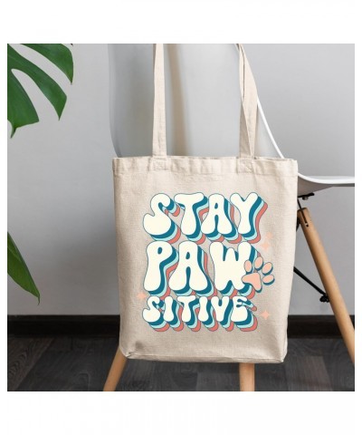 Stay Pawsitive Pun with a Dog or Cat Paw Art Merch Gift, 12oz Canvas Tote Bag $14.30 Totes